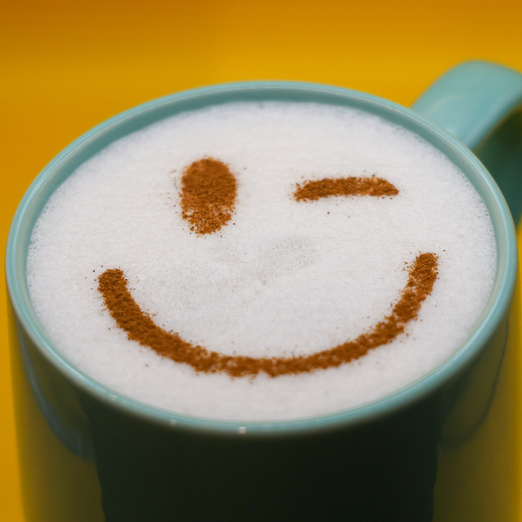Reusable Coffee Stencils creating winking smiley face latte art design