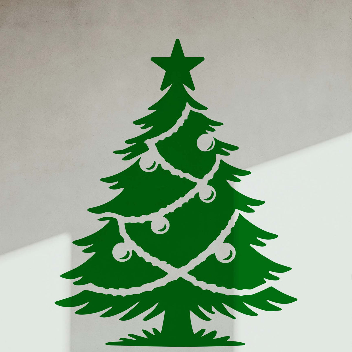 Green Classic Decorated Christmas Tree Stencil shown as a window decal against a bright interior.