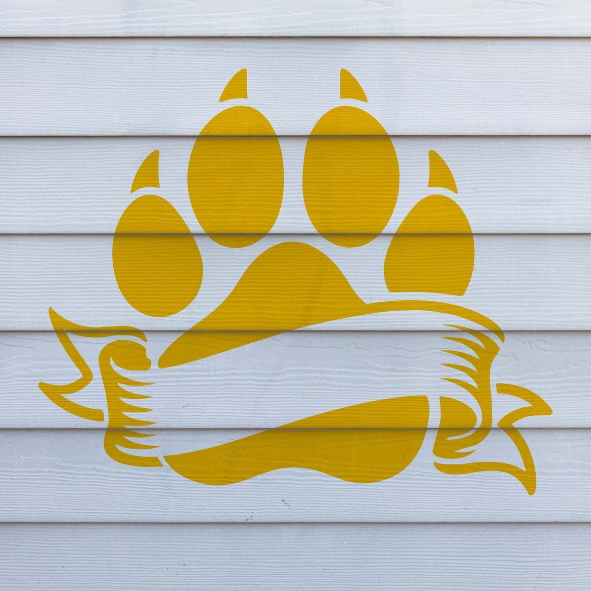 Across white siding, the Blank Banner Paw Print Stencil features a golden paw and curled ribbon