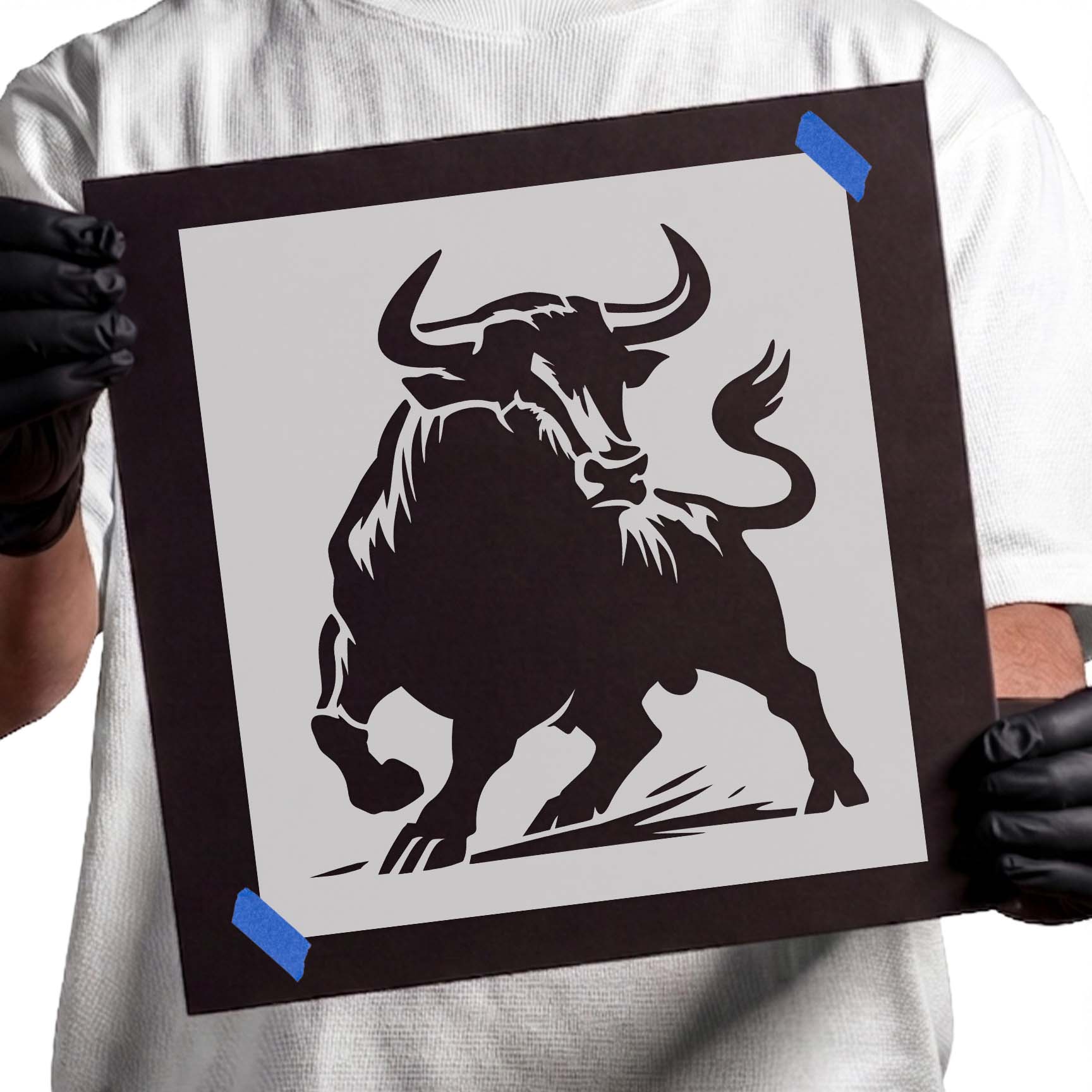 Charging bull stencil with curved horns, raised hoof, and lifted tail