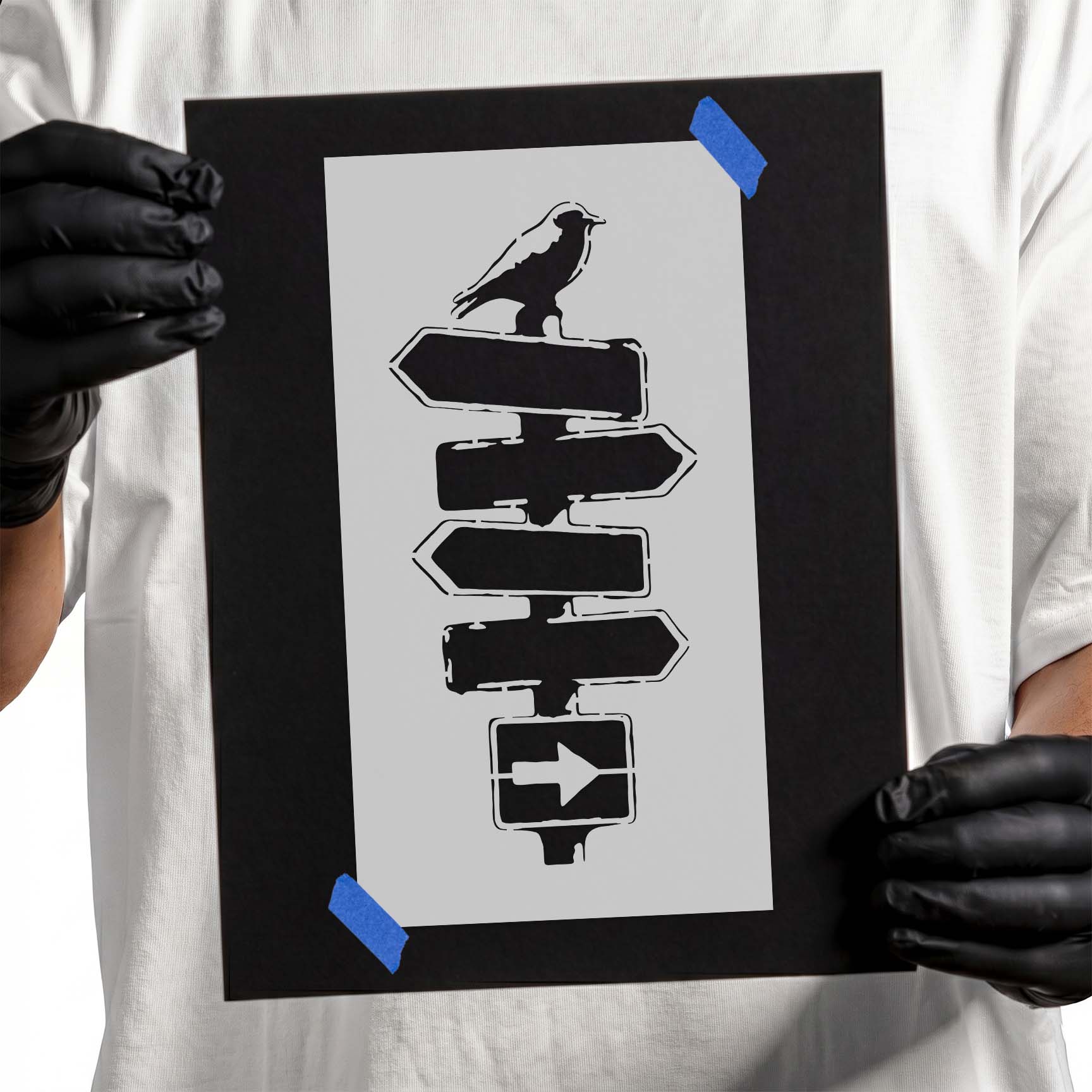 Crow perched on rustic multi-directional signpost stencil silhouette