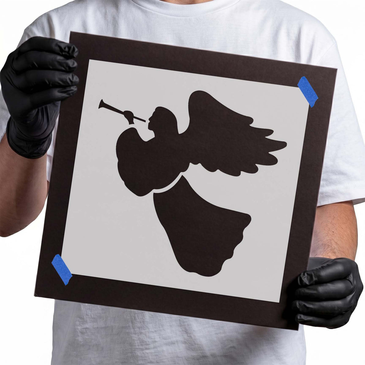 Flying angel stencil with trumpet, outstretched feathered wings, and flowing gown