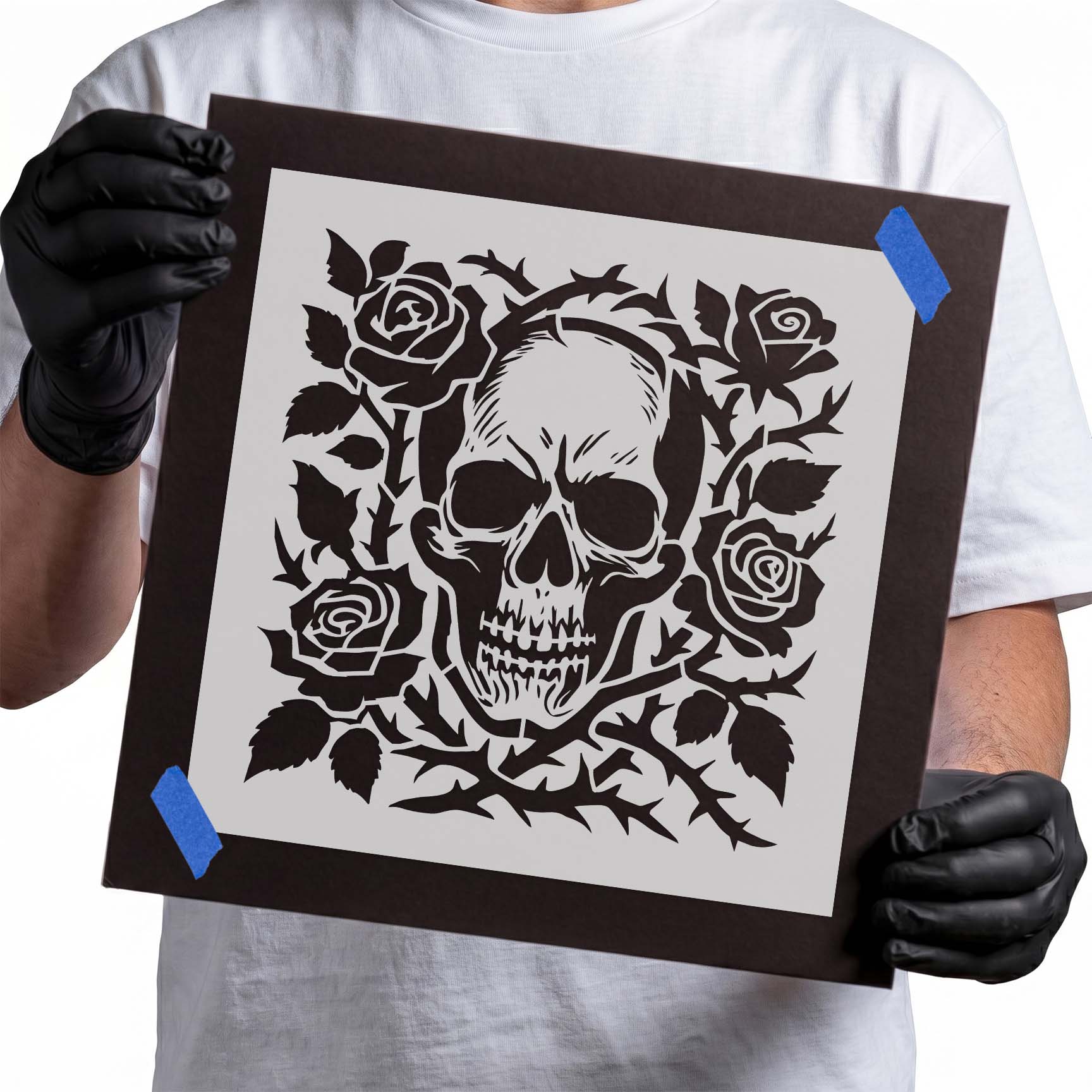 Detailed skull surrounded by roses and thorny vines stencil design
