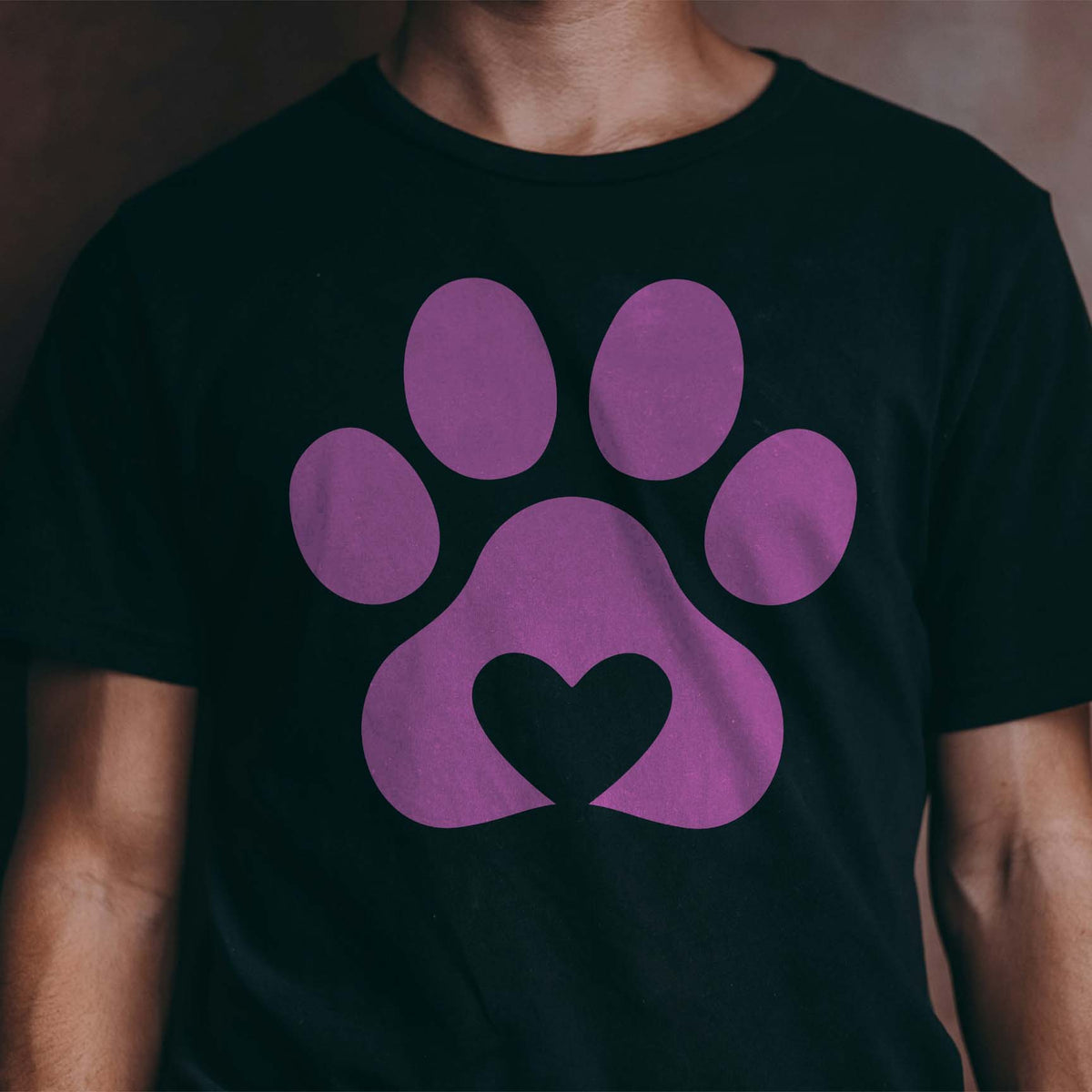 Purple Heart Paw Print Stencil stands out across the chest of a black T-shirt