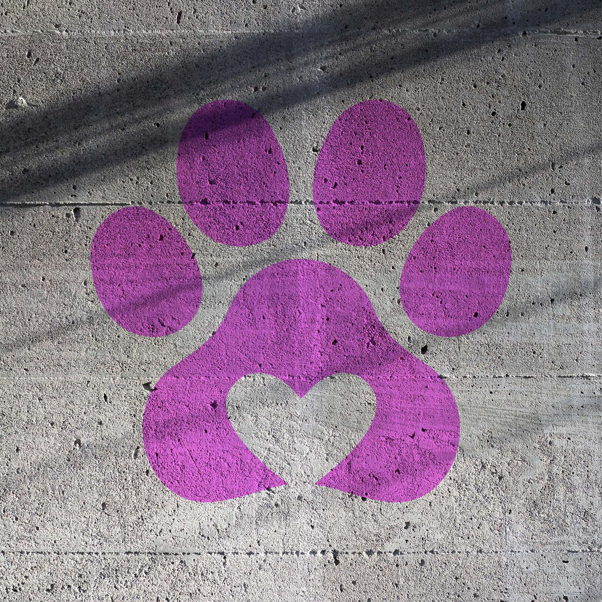 Bold purple Heart Paw Print Stencil adds a loving paw motif to textured concrete