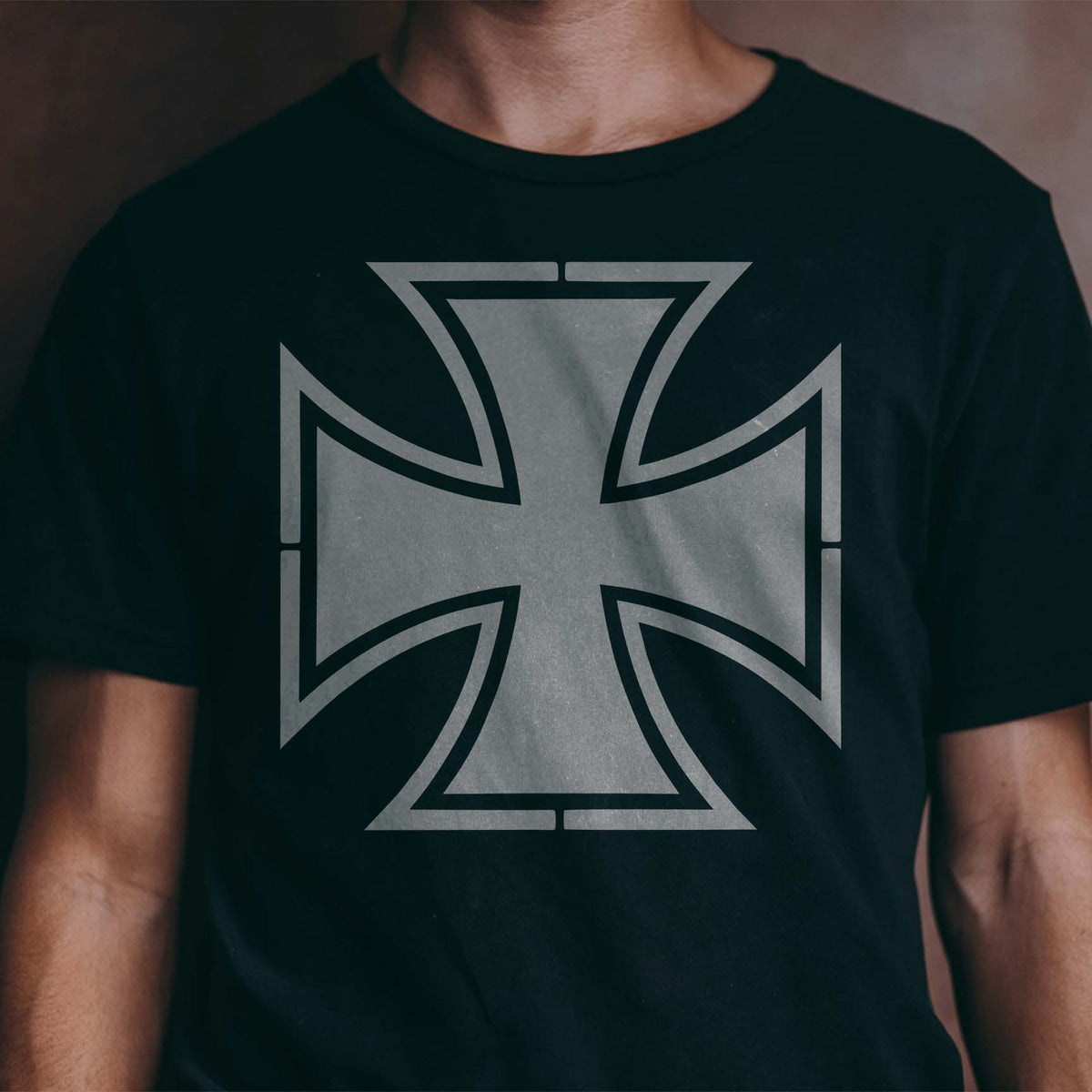 Silver Iron Cross Stencil displayed boldly across the front of a black T-shirt