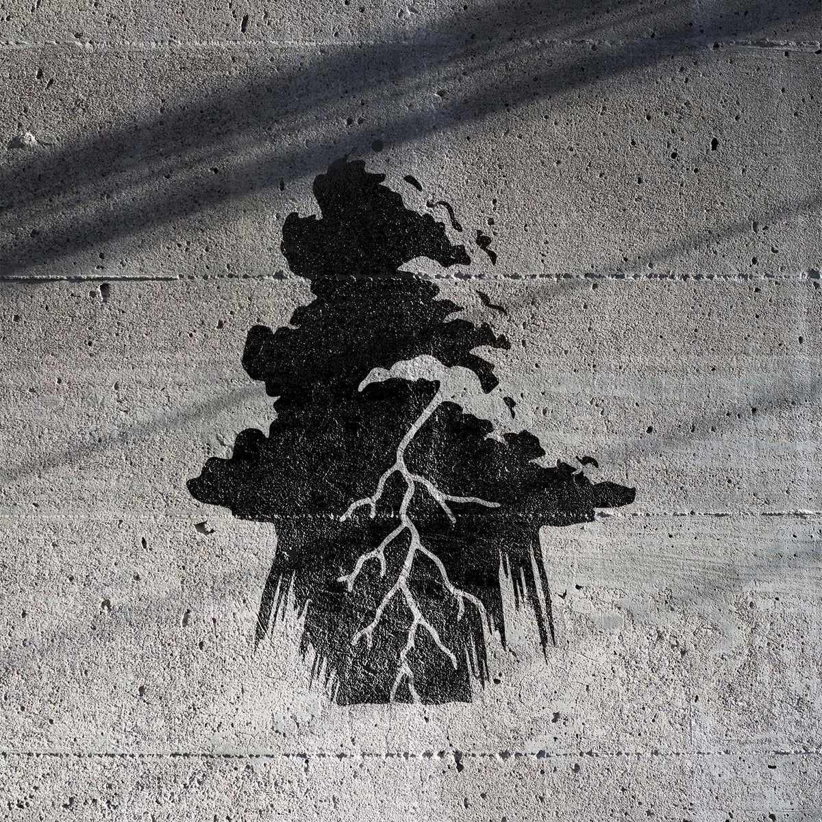 Black Lightning Storm Cloud Stencil casts branching lightning across a textured concrete wall
