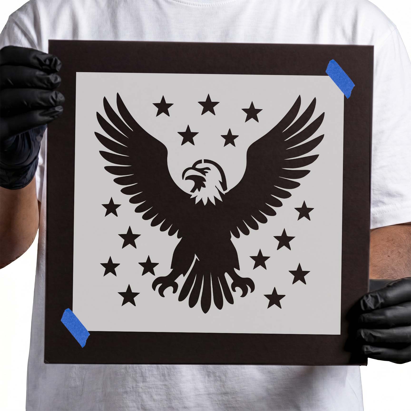 Bald eagle with outstretched wings surrounded by stars stencil design