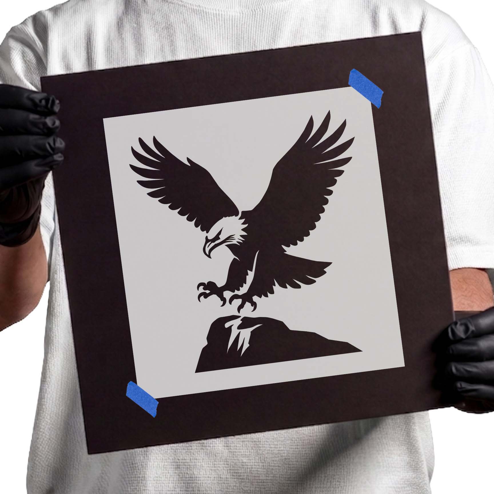 Bald eagle landing on a rocky perch with wings spread stencil