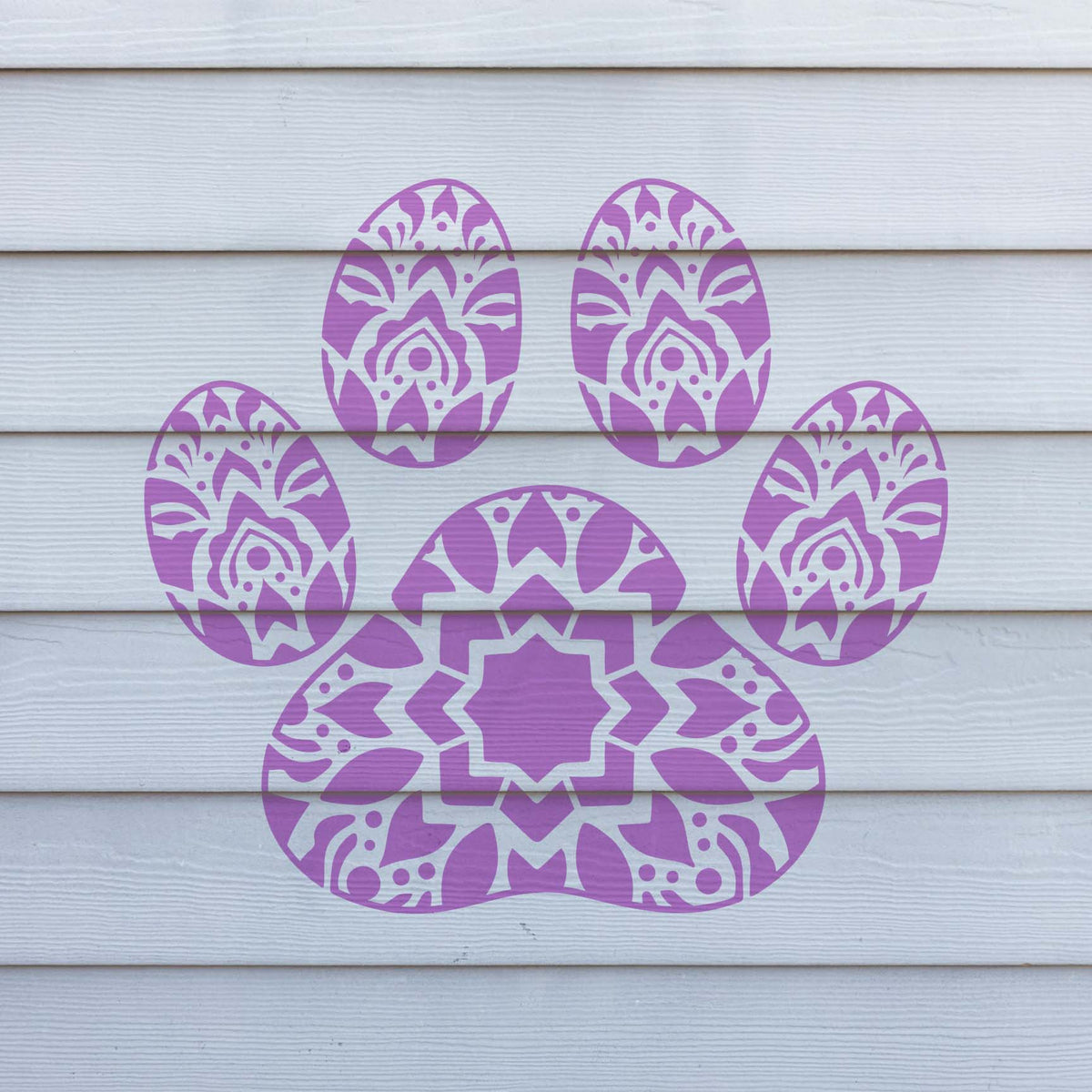 Vibrant purple Mandala Paw Print Stencil stands out across white horizontal wall siding