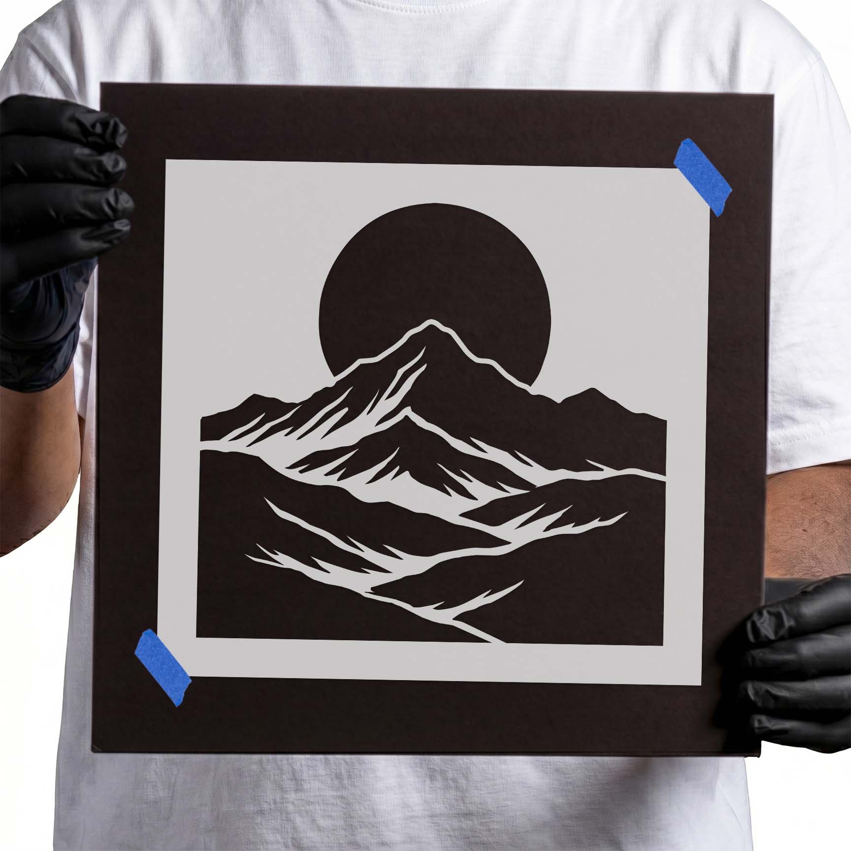 Layered mountain landscape beneath a bold full moon silhouette
