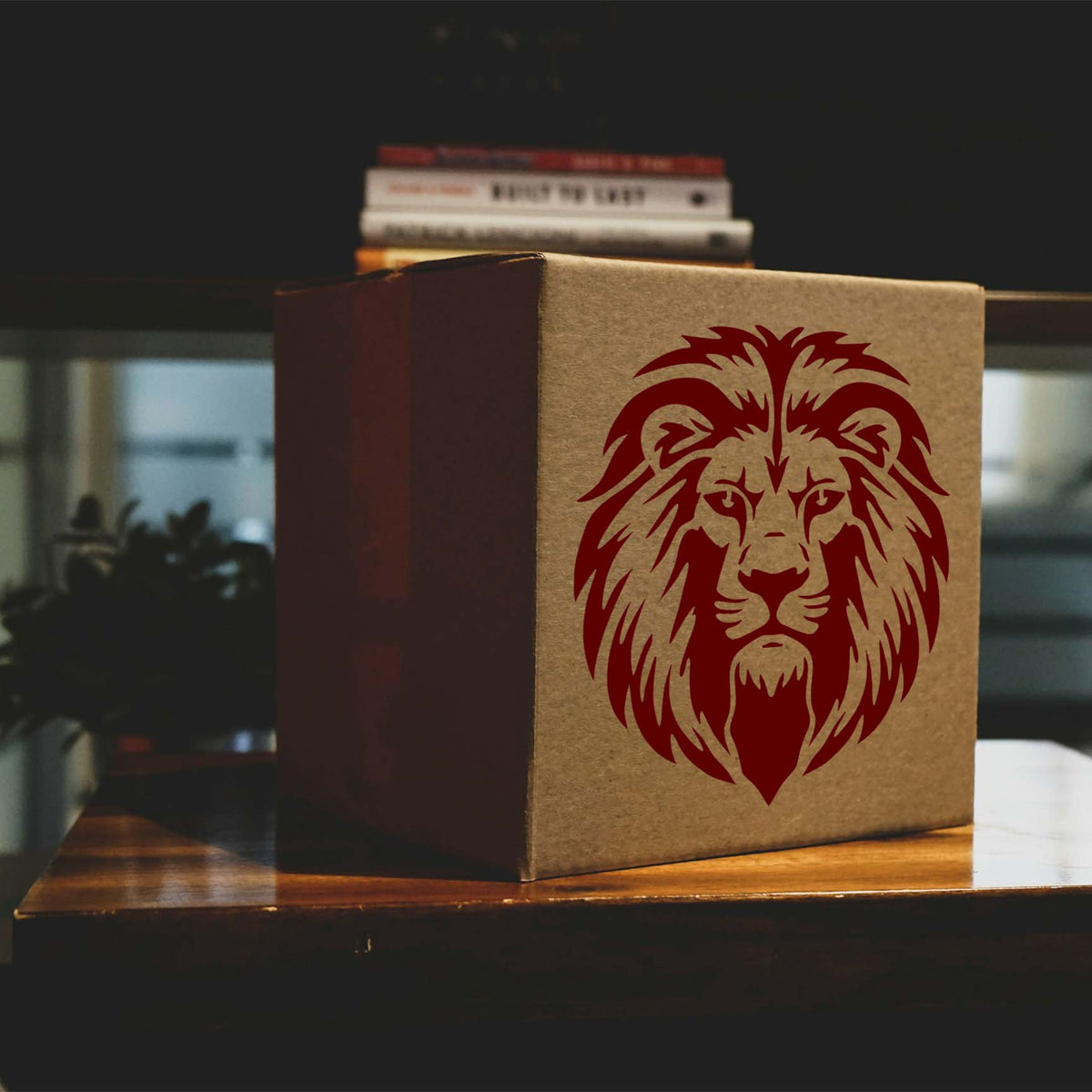 Red Regal Lion Head Stencil adds a bold mane design to the front of a cardboard box.