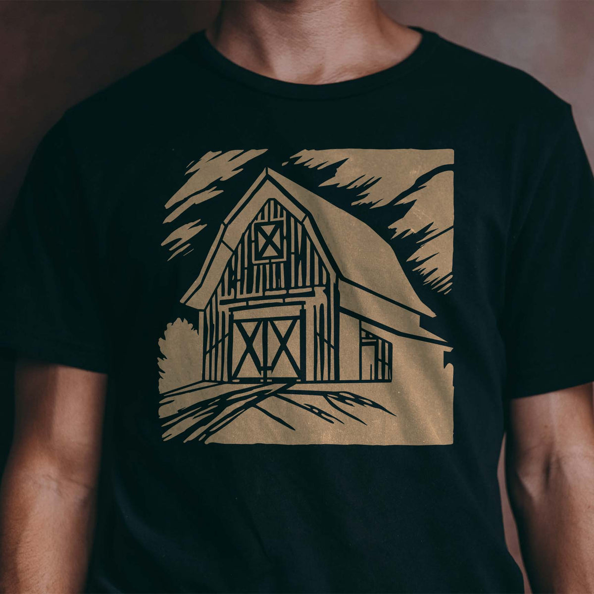 Rustic Country Barn Landscape Stencil printed in tan on a black shirt with classic barn scenery