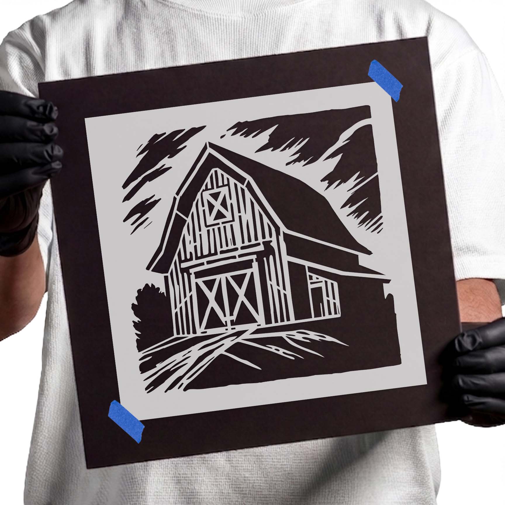 Person holding Rustic Country Barn Landscape reusable Mylar stencil