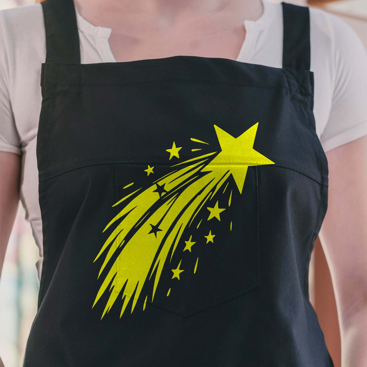 A bright Shooting Star Trail Stencil sweeps across a black apron with scattered stars