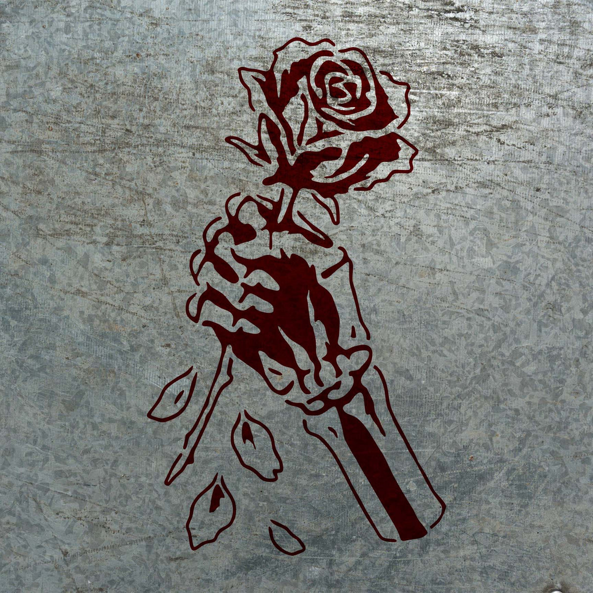 Deep red Skeleton Hand Holding Rose Stencil stands out against weathered galvanized metal