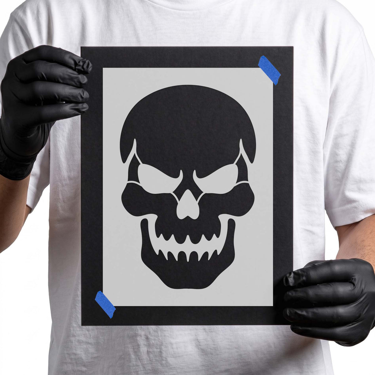 Halloween skull stencil depicting hollow eyes, angular cheekbones, and a sinister jagged grin
