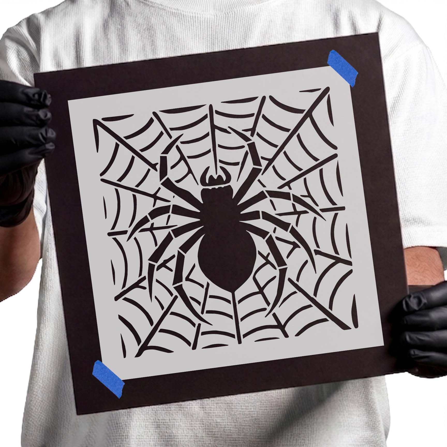 Spider silhouette centered in an intricate web stencil