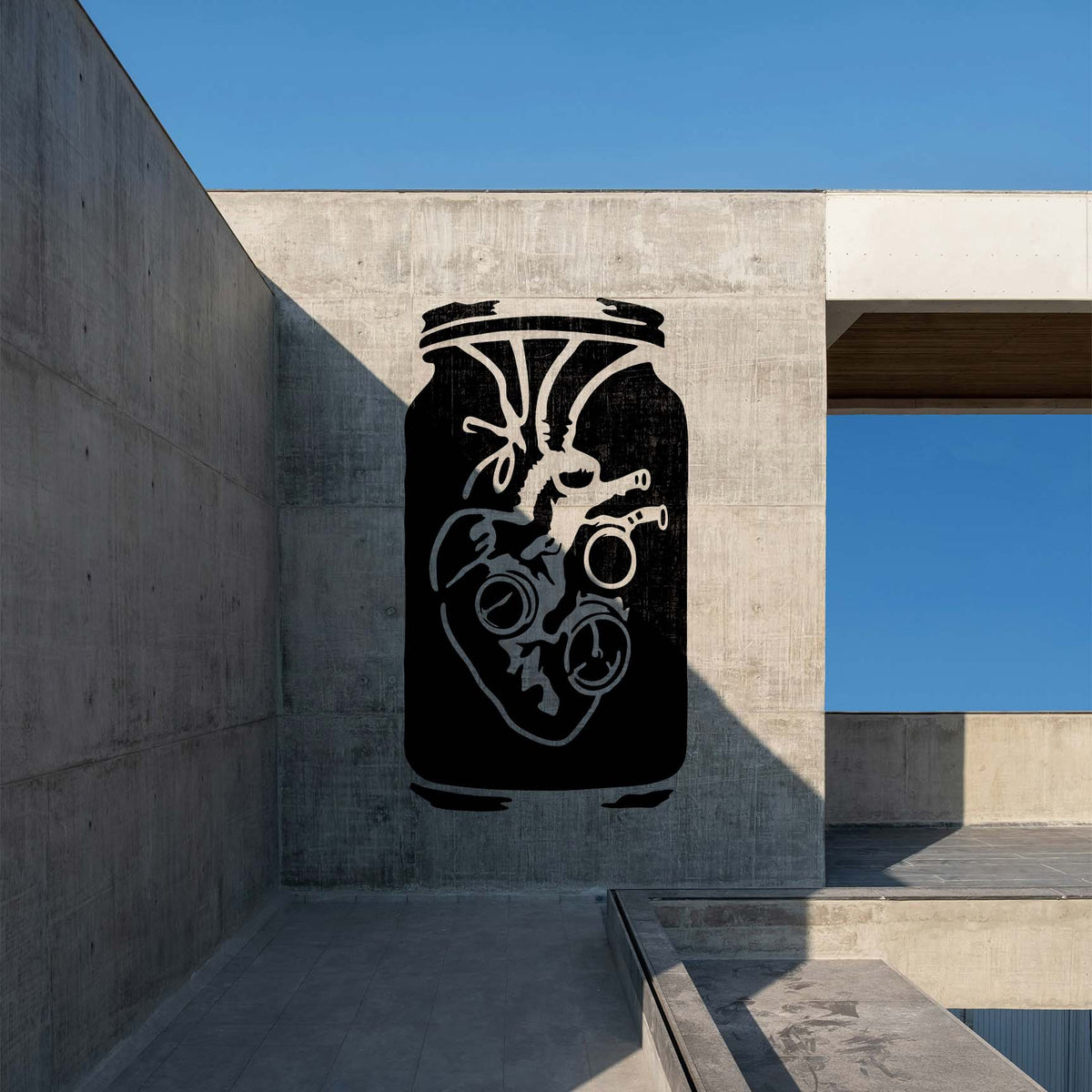 Steampunk Anatomical Heart Jar Stencil painted as a bold black mural on a concrete wall.