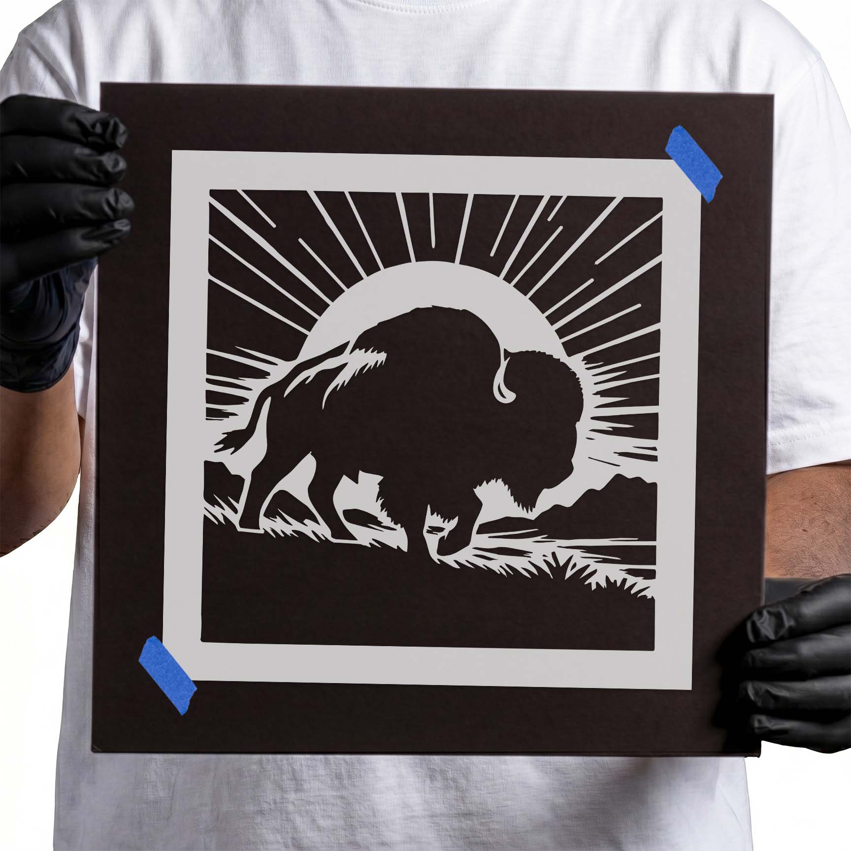 Sunrise buffalo silhouette stencil with radiant sun and prairie landscape