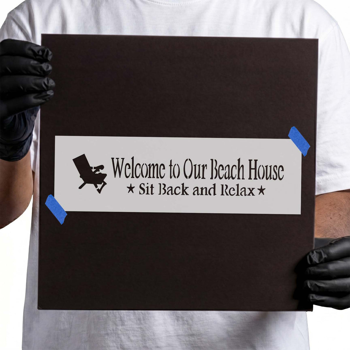 Beach house stencil with welcome lettering, reclining chair, stars, and relax phrase