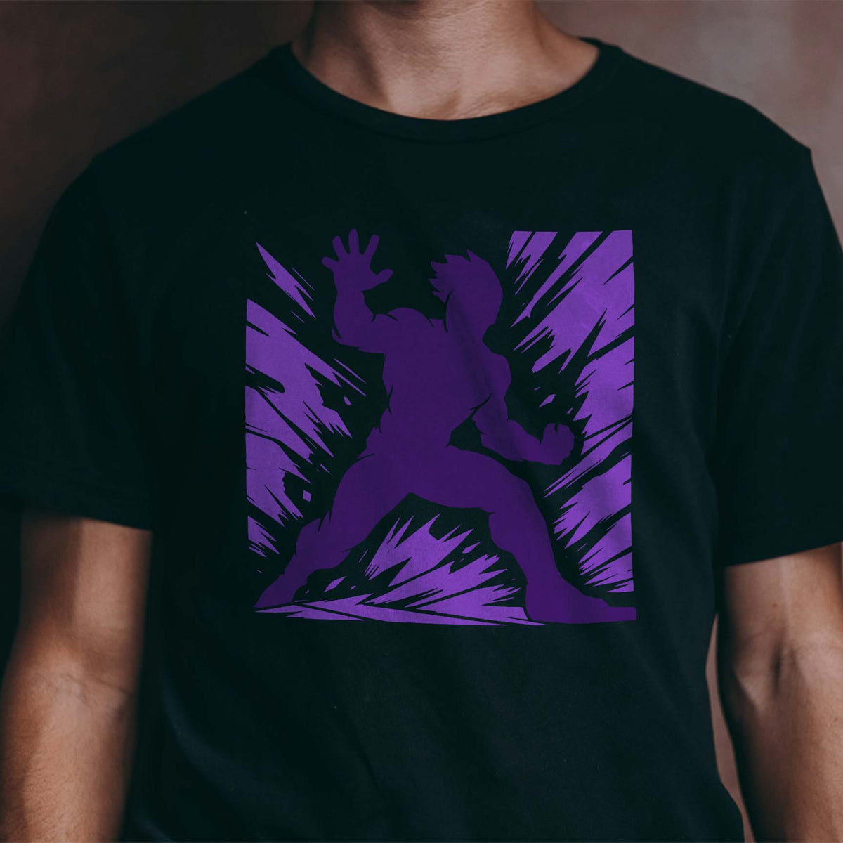 Action Hero Silhouette Stencil bursts in purple across a black T-shirt with comic-style energy