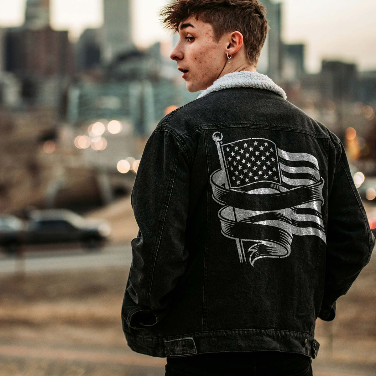 Silver American Flag Banner Stencil makes a striking statement across the back of a black denim jacket