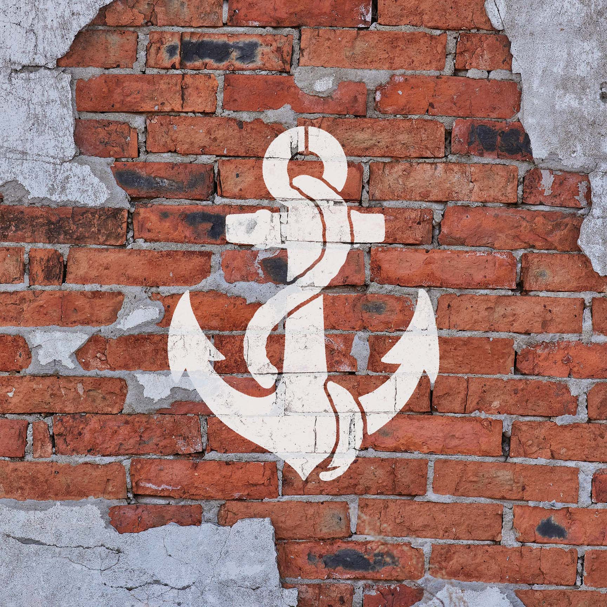 White Anchor with Rope Stencil adds a bold maritime emblem to a weathered red brick wall