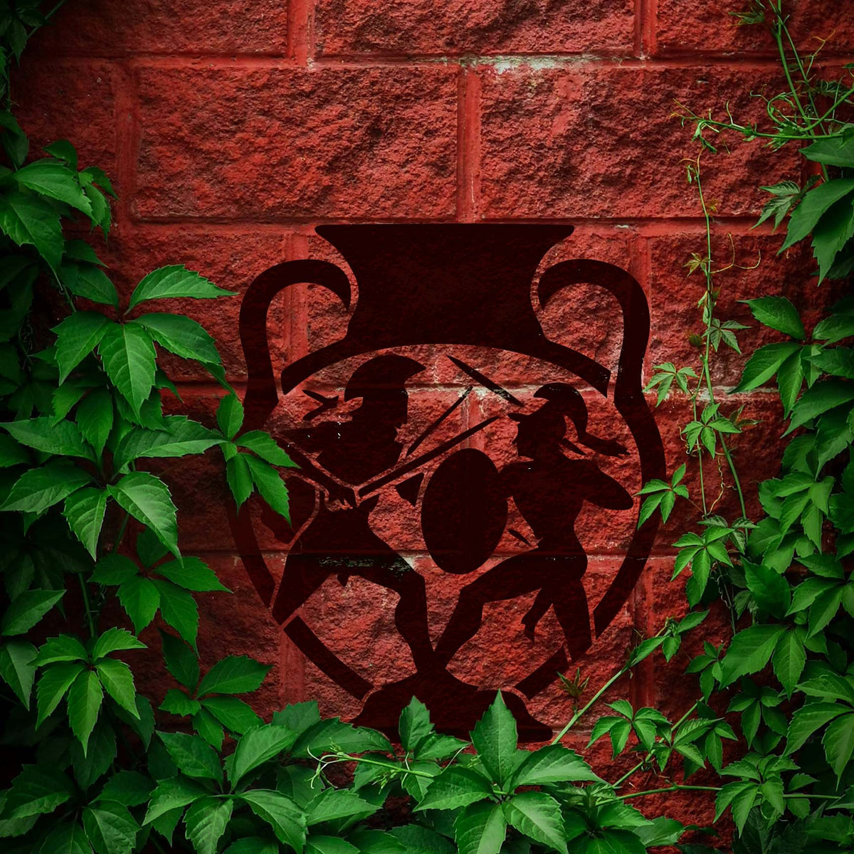 Ancient Greek Warriors Vase Stencil painted on a red brick wall surrounded by green vines.