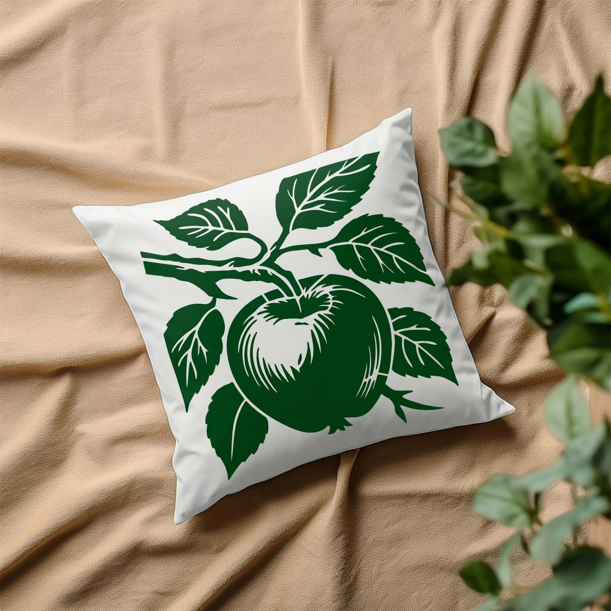 A green Apple on Tree Branch Botanical Stencil brings leafy fruit detail to a white throw pillow.