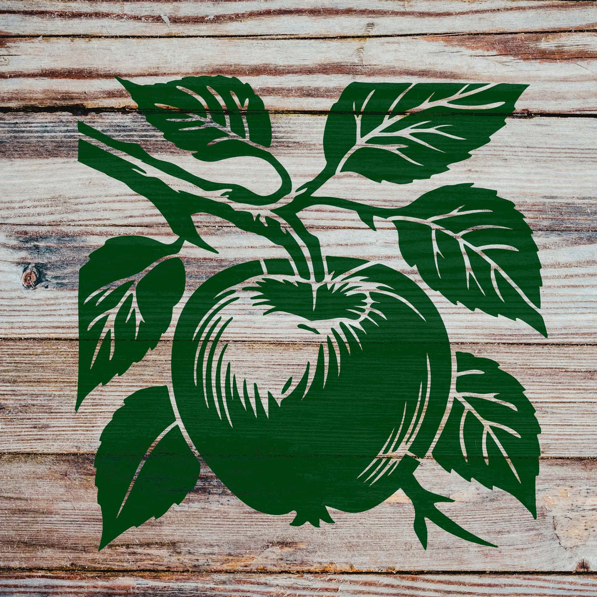 Rustic wooden planks showcase the Apple on Tree Branch Botanical Stencil in rich green with leafy details.
