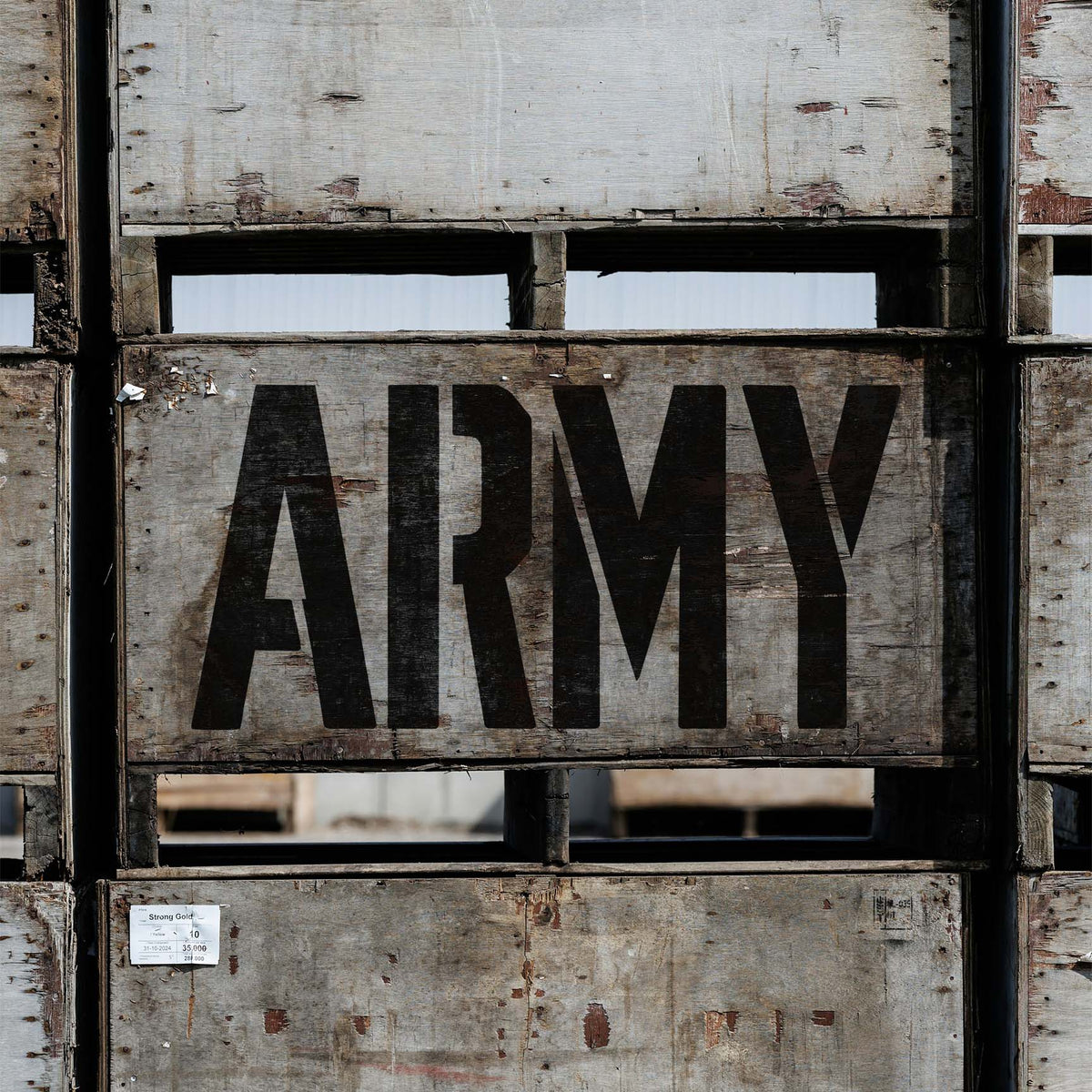 Army Word Stencil in bold black lettering displayed on rustic wooden crates.