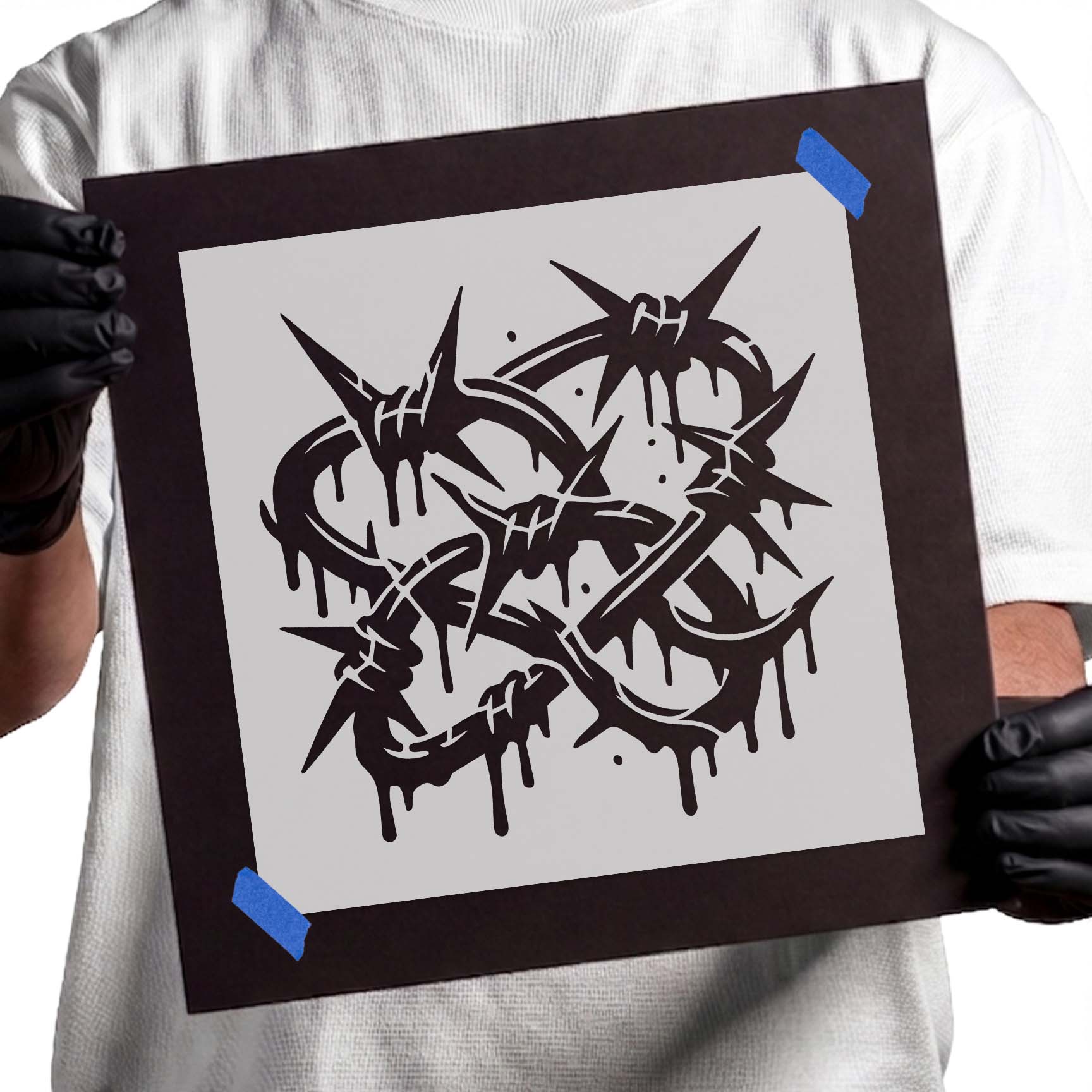 Person holding Graffiti Barbed Wire reusable Mylar stencil