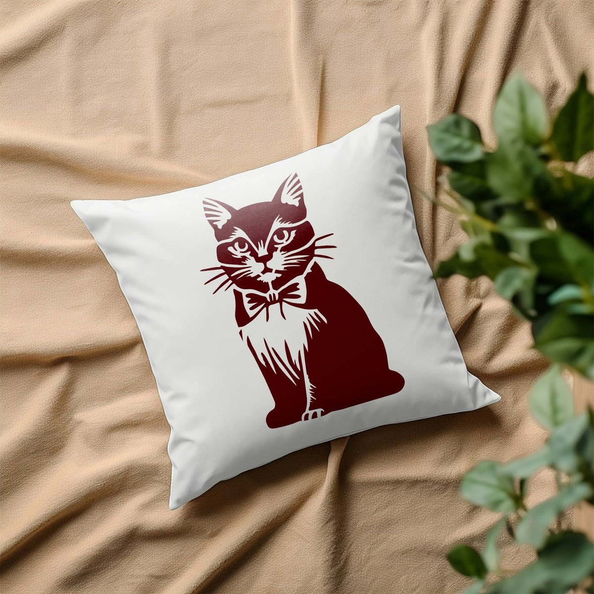A stylish Bow Tie Cat Stencil shows a poised feline with a bow tie on a white decorative pillow.