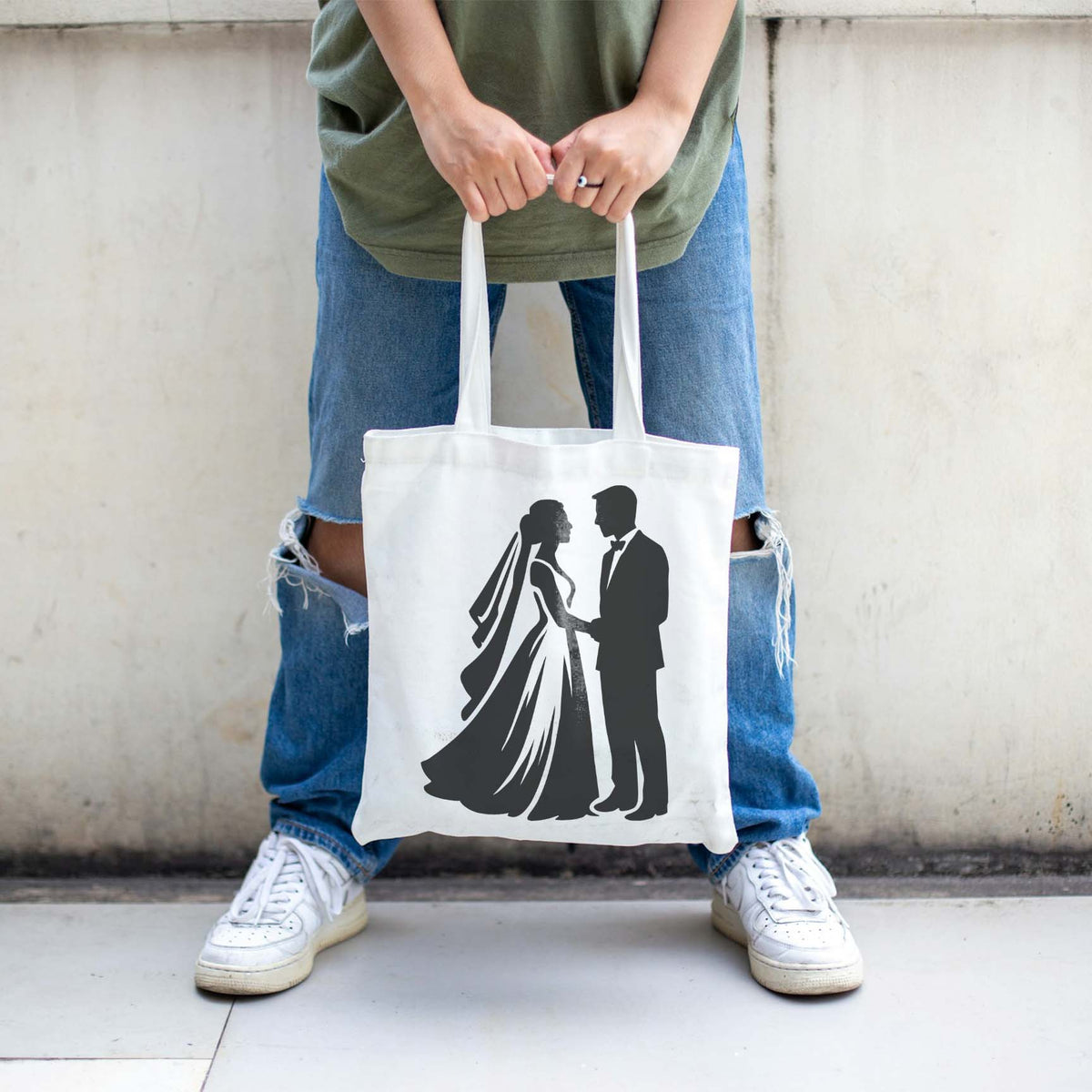 Bride and groom silhouette stencil printed black on a white tote bag