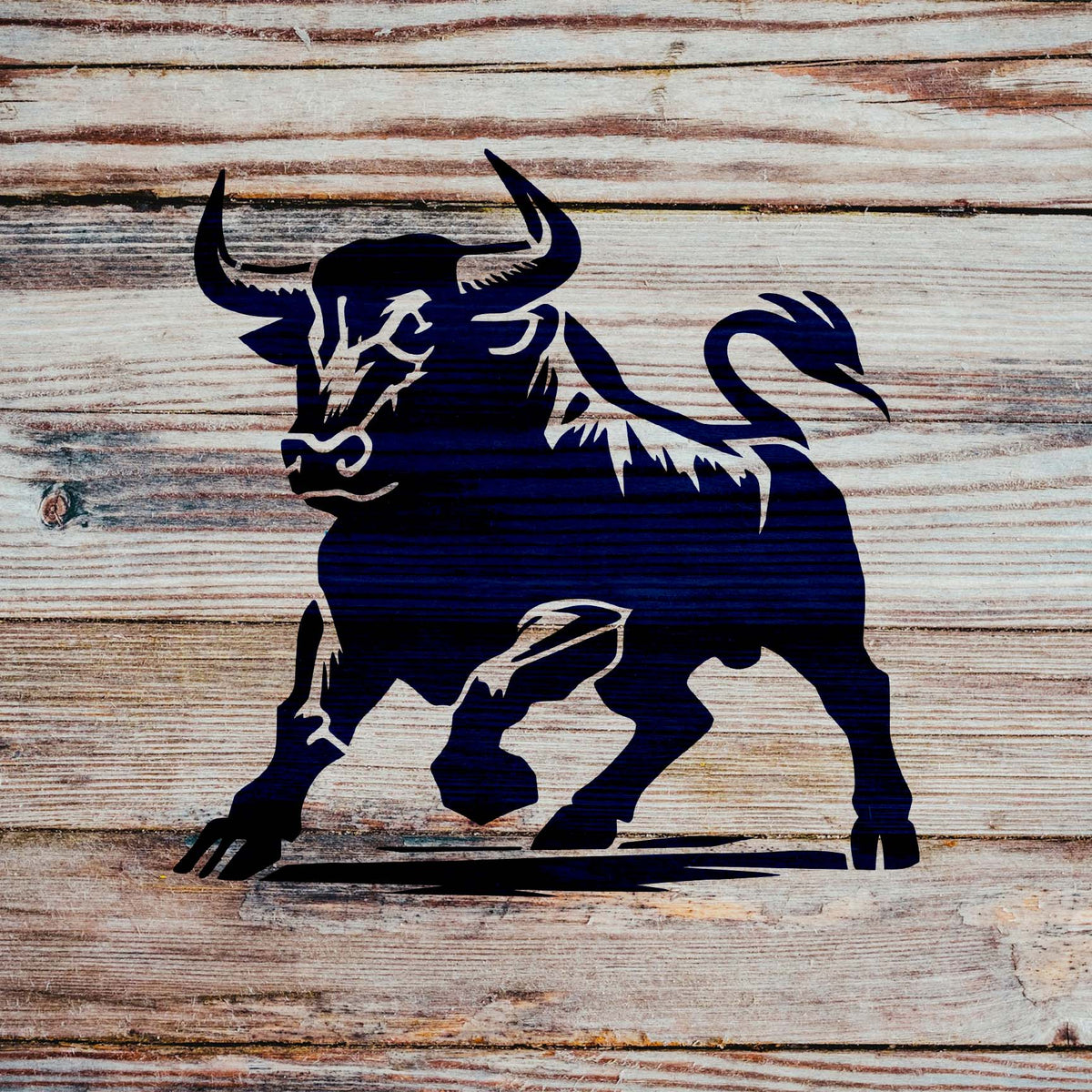 Fierce Bull Stencil painted on rustic wood showing a bold horned bull with raised hoof.