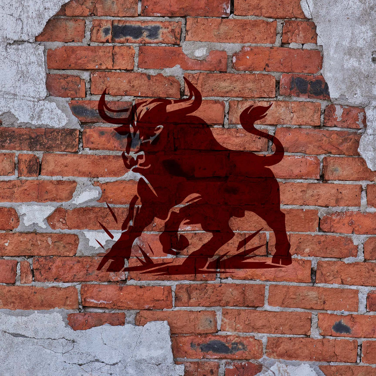 Horned Bull Stencil painted dark red on an exposed brick wall with a charging bull design.