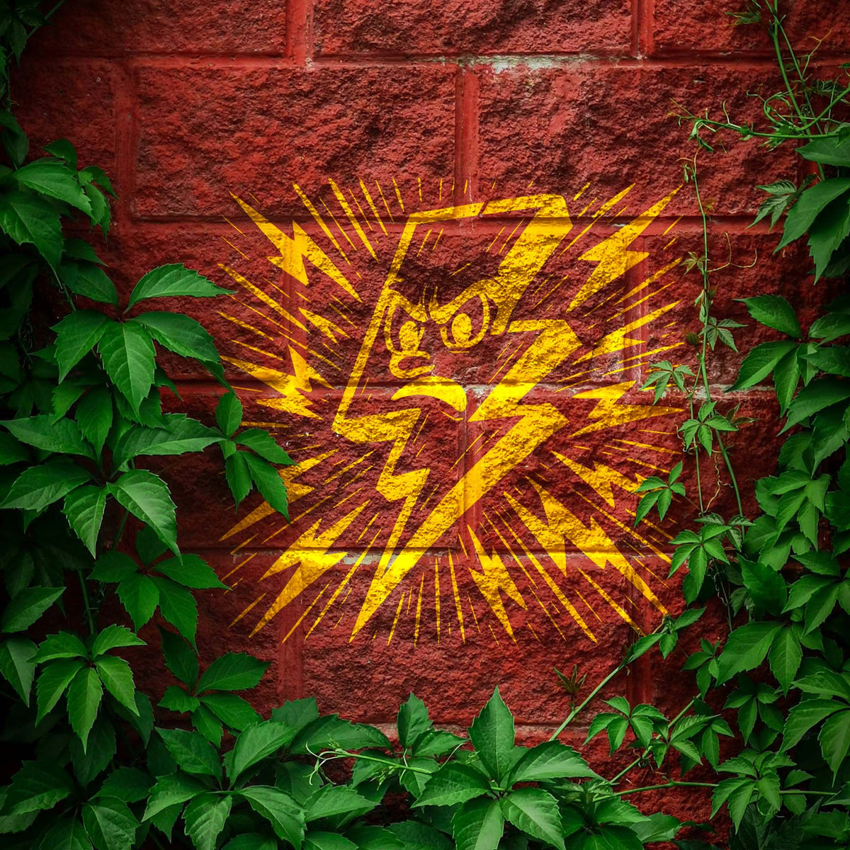 Framed by green vines, the Cartoon Lightning Bolt Stencil flashes bright yellow on a brick wall