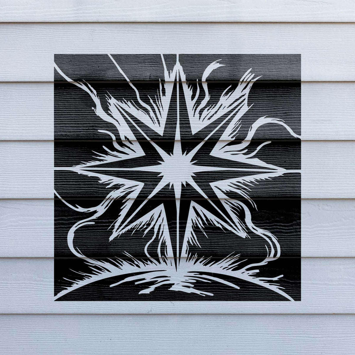 White Celestial Starburst Stencil radiates across a black panel on exterior siding