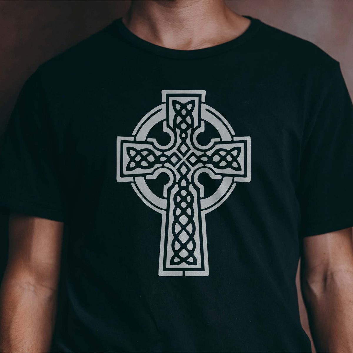 Celtic Knot Cross Stencil printed in white on a black T-shirt mockup.