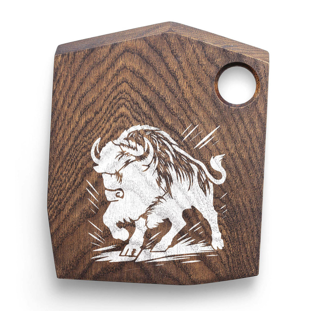 A white Charging Bison Stencil captures a muscular bison in full motion on a wooden cutting board.
