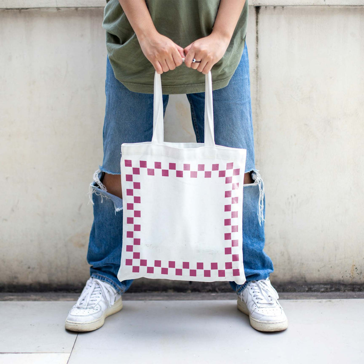 Pink squares from the Checkerboard Border Frame Stencil add a retro touch to a white tote bag.