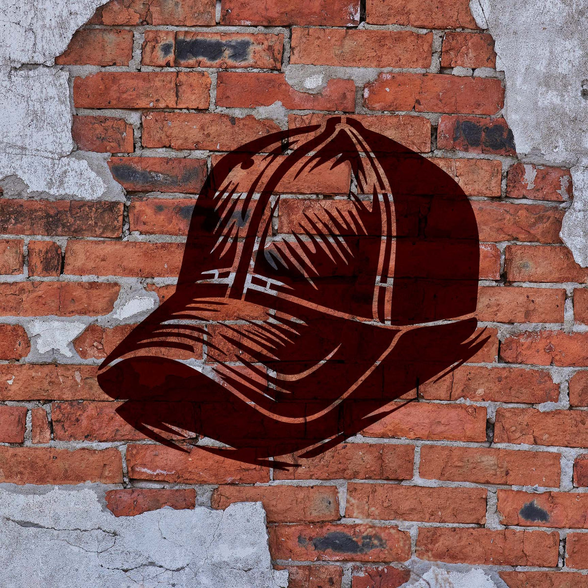 A burgundy Classic Baseball Cap Stencil with curved brim and stitched panels stands out on a weathered brick wall.