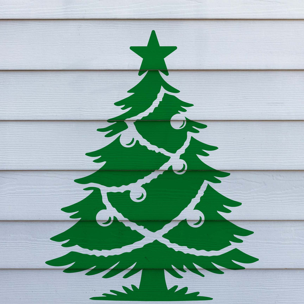 Classic Decorated Christmas Tree Stencil displayed on white siding for a clean outdoor wall look.