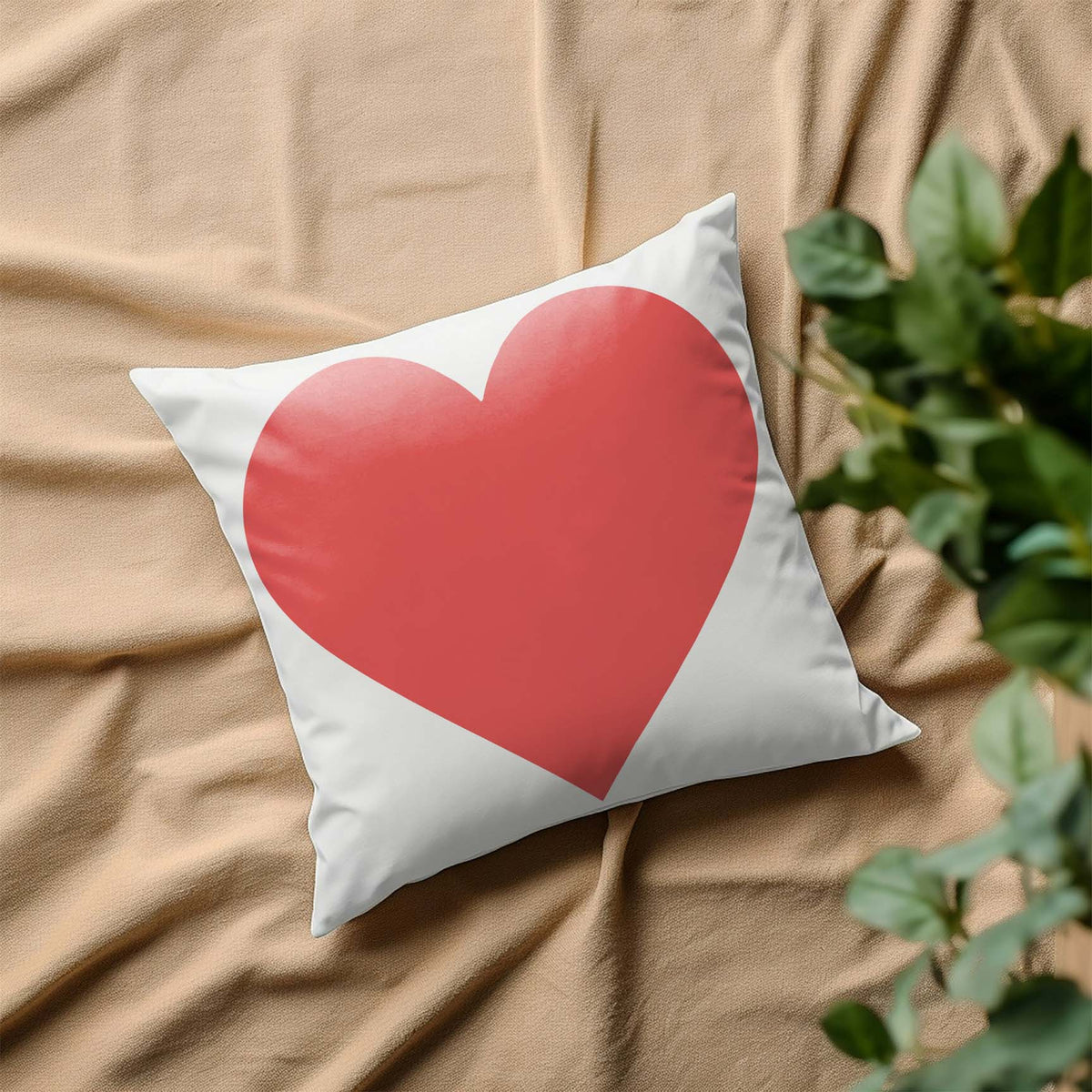 A sweet pink Classic Heart Stencil brings a romantic touch to a white pillow nestled on soft beige fabric.