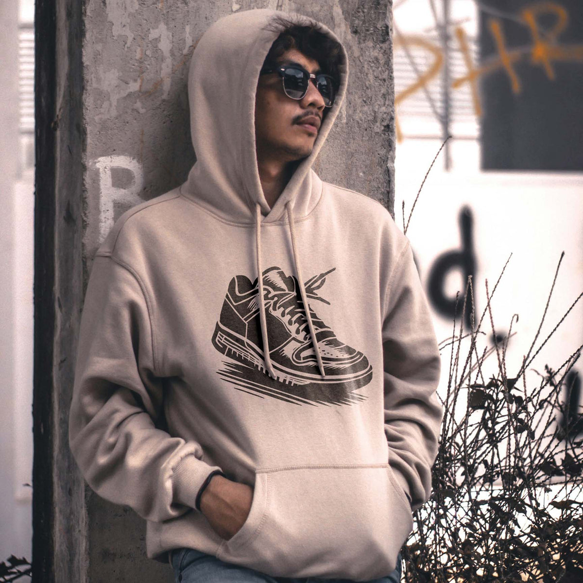 Streetwear style meets the Classic Low Top Sneaker Stencil, printed in dark gray on a beige hoodie.