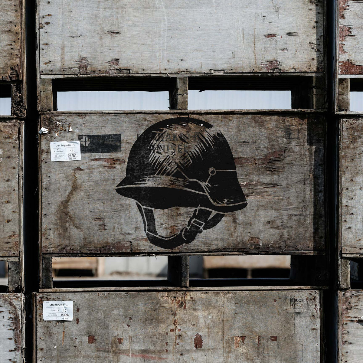 A vintage black Classic Military Helmet Stencil adds rugged military character to weathered wooden crates.