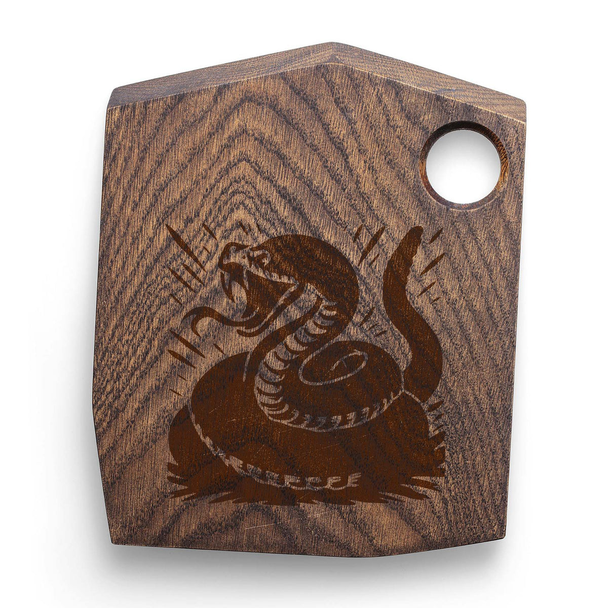 Fierce rattlesnake stencil with open fangs on dark wooden board