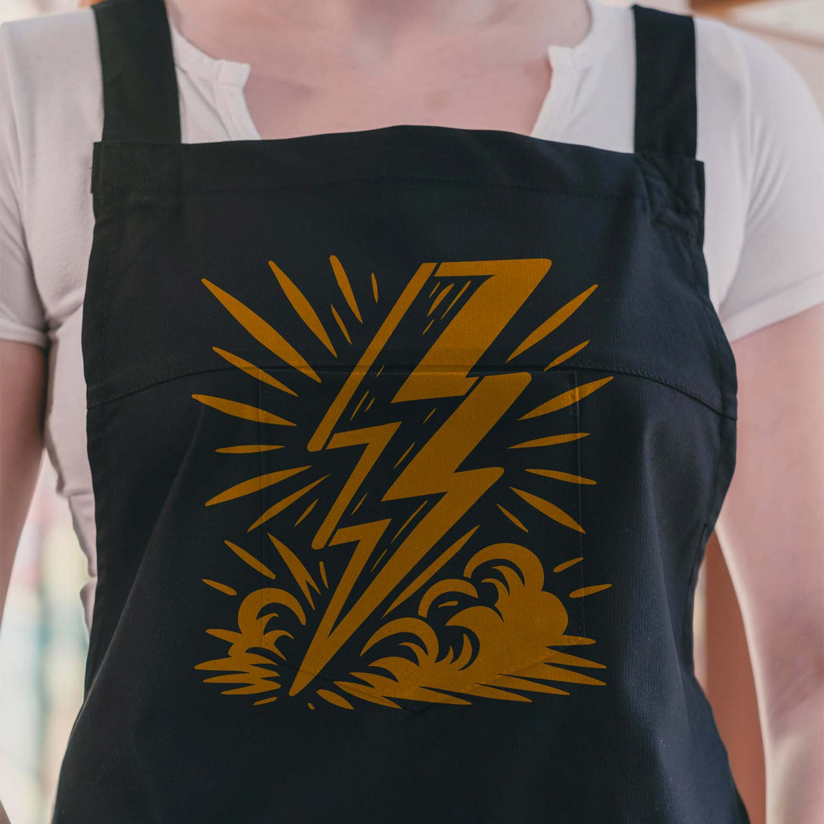 Golden Comic Lightning Bolt Burst Stencil strikes through clouds across a black apron