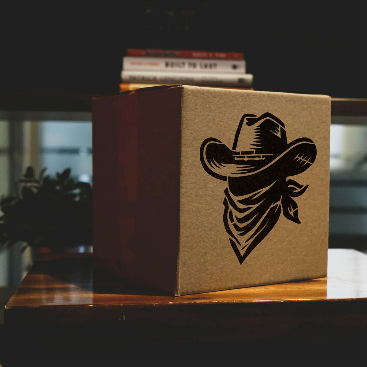 A bold black Cowboy Hat & Bandana Stencil brings Western flair to a brown cardboard box.